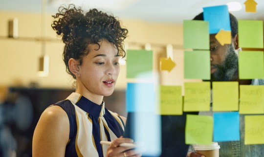 Woman planning with Post-It Notes